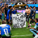 Argentina Falklands banner displayed by players wearing dark blue away jerseys after the World Cup semi-final